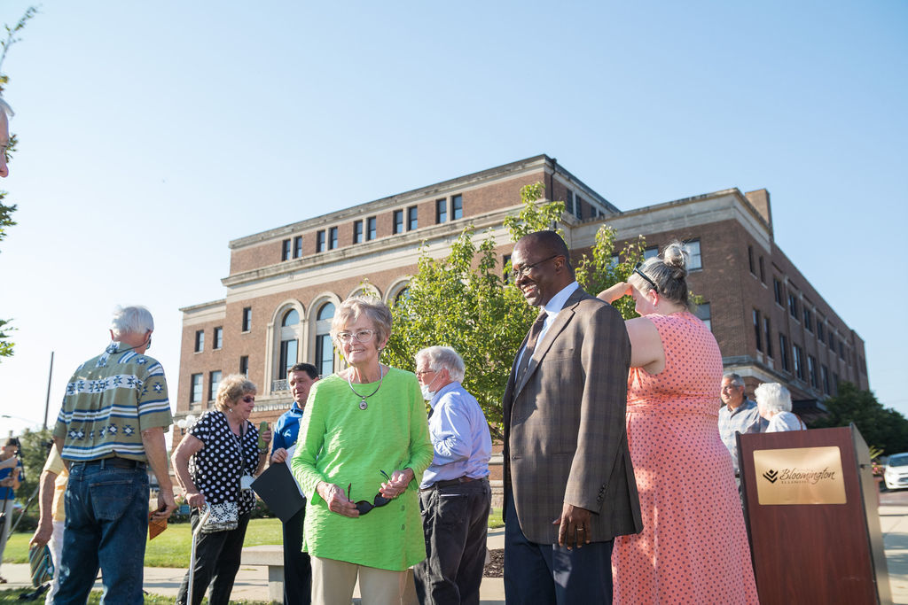 Judy Buchanan and Bloomington Mayor Mboka Mwilambwe look at the tree planted in Rich Buchanan’s honor